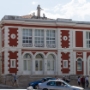 The theatre building from 1886 with three vaults on the ground floor, two Porec’s coat of arms on the façade and three sculptures on the roof.